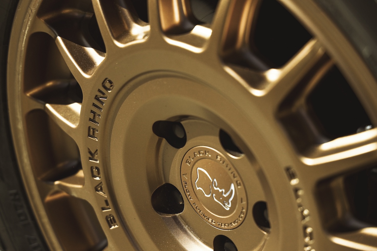 Close-up of a gold Black Rhino wheel with VNOX hardware